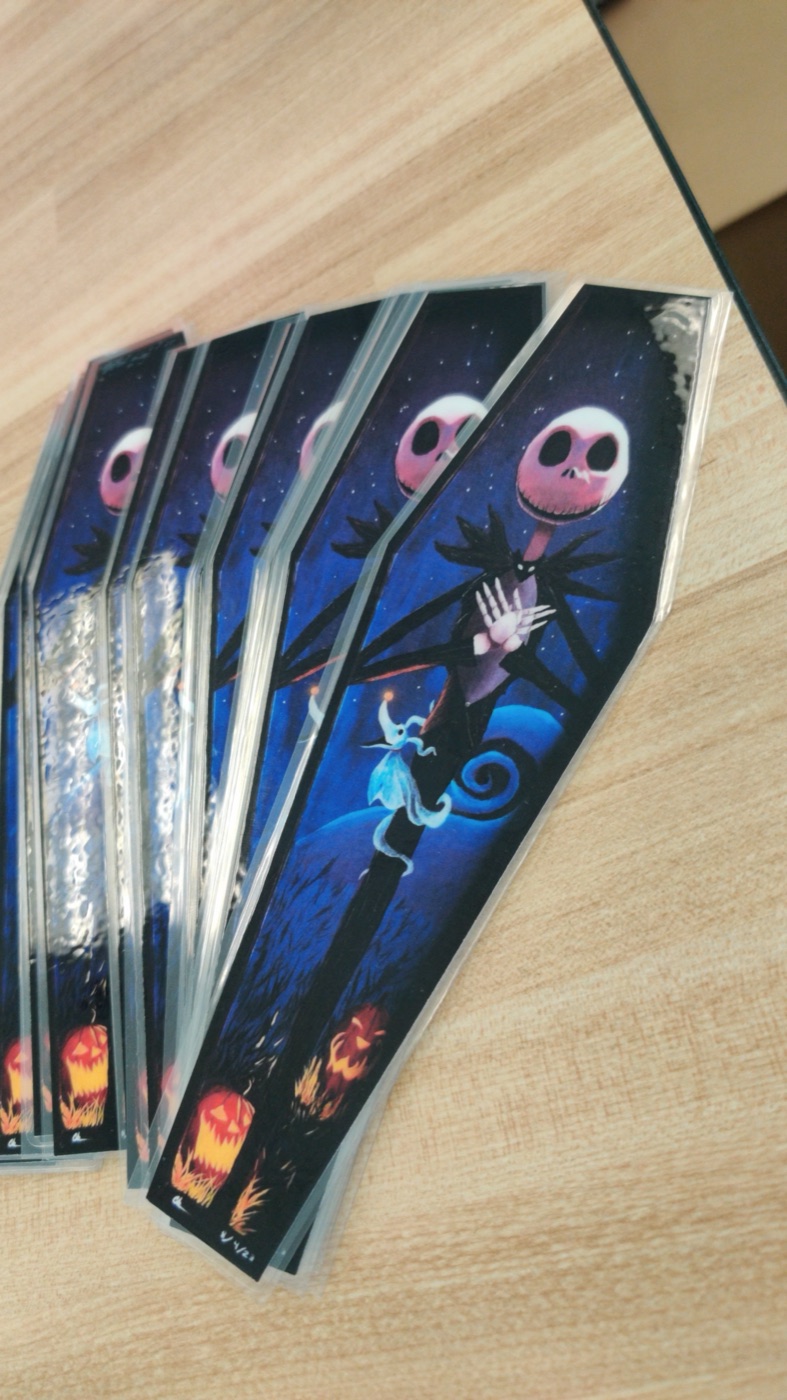 Fan of Jack Skellington coffin-shaped prints on a tabletop
