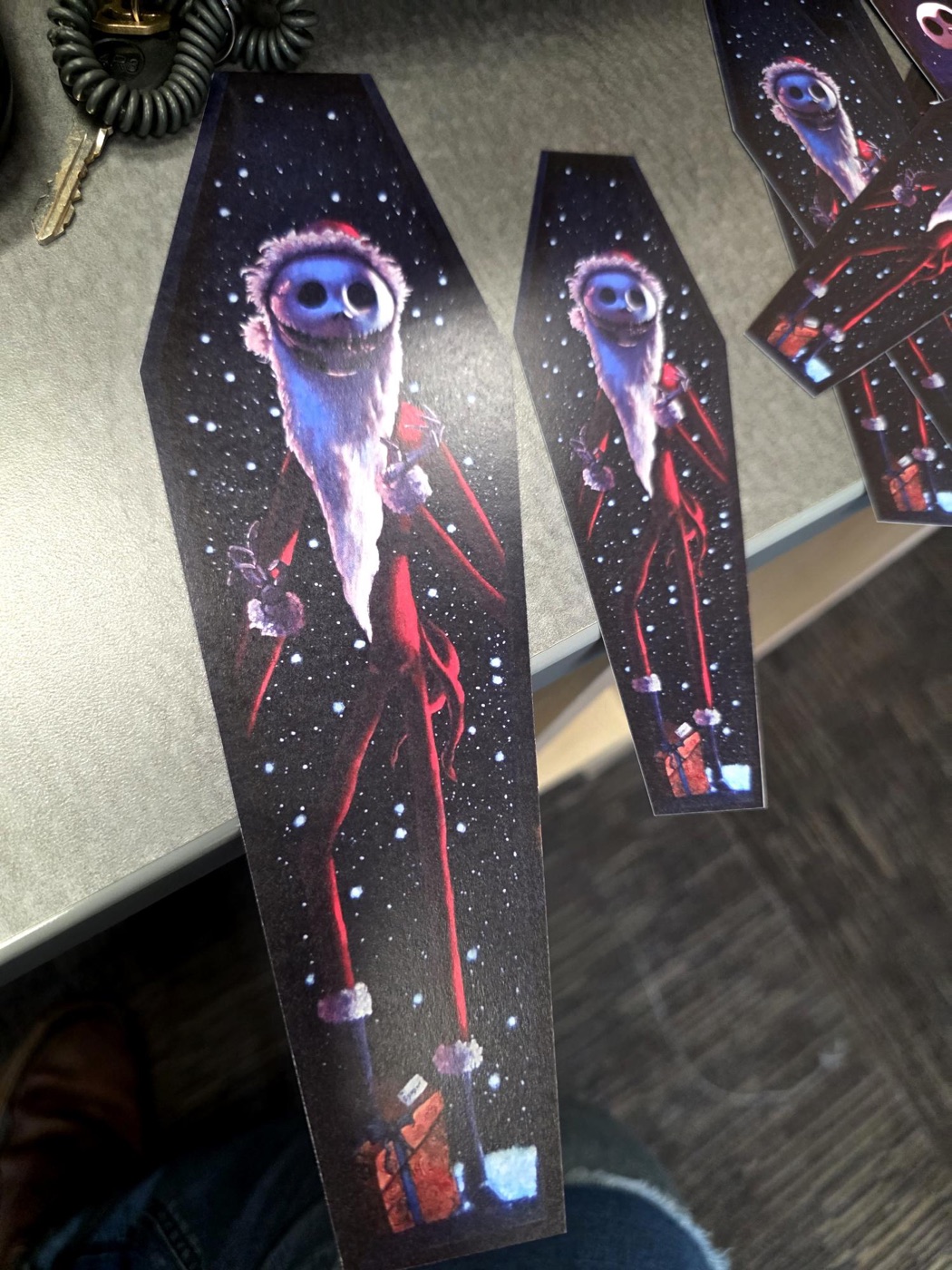 Red and black Jack Skellington coffin-shaped prints laid out on a table