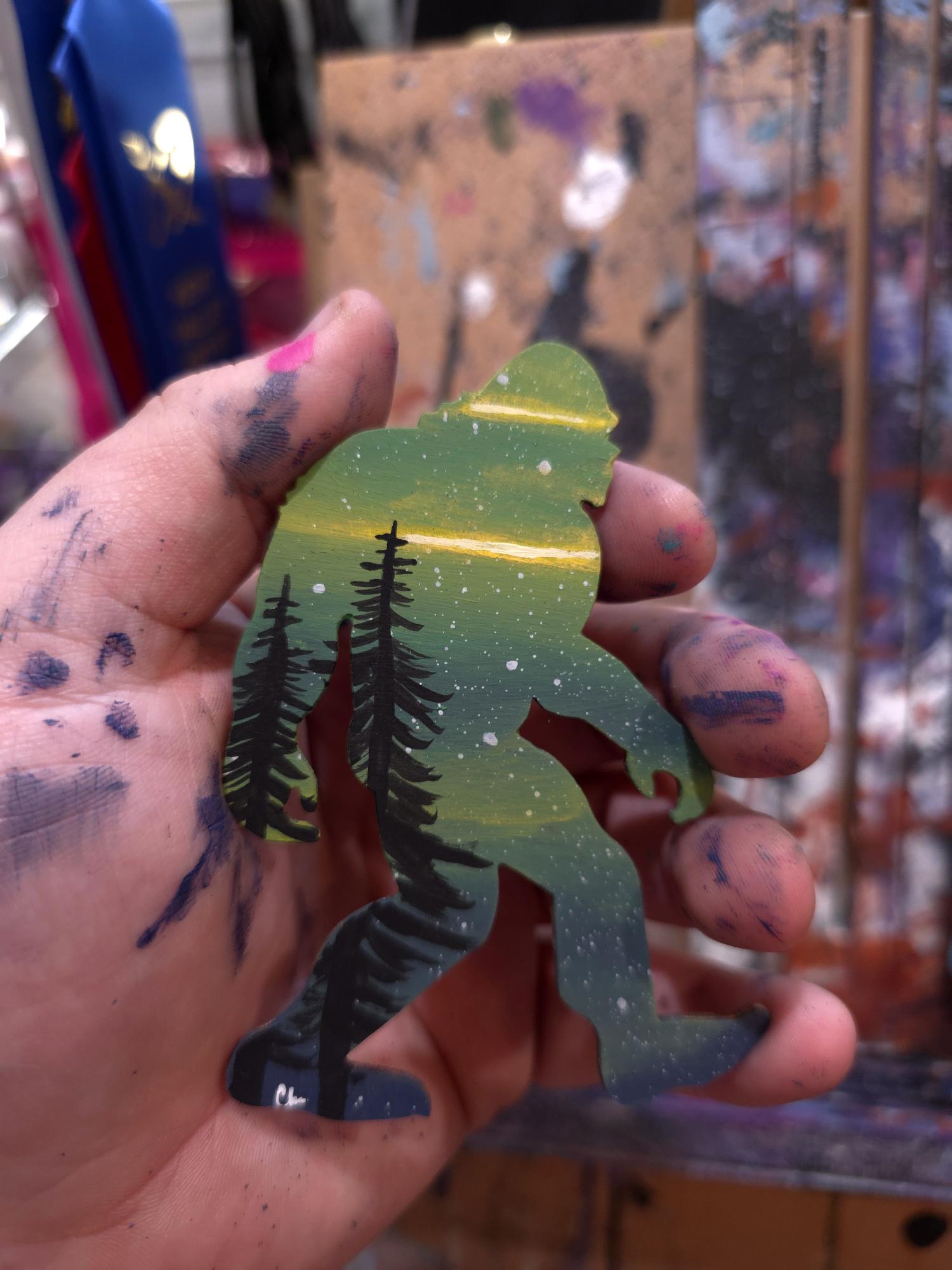 Green and gold Sasquatch sample with dark pine trees