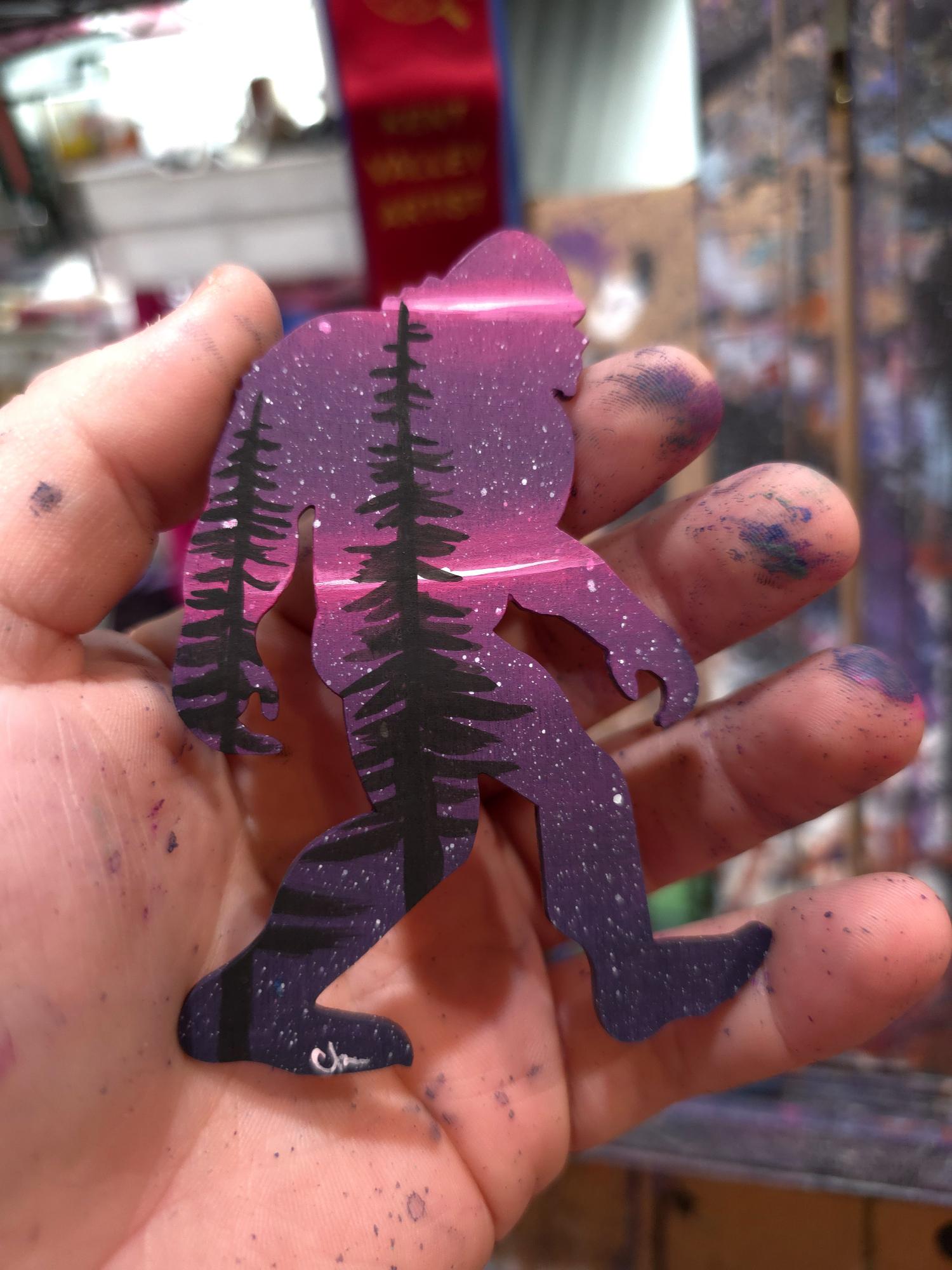 Purple made-to-order Sasquatch with black pine trees and stars